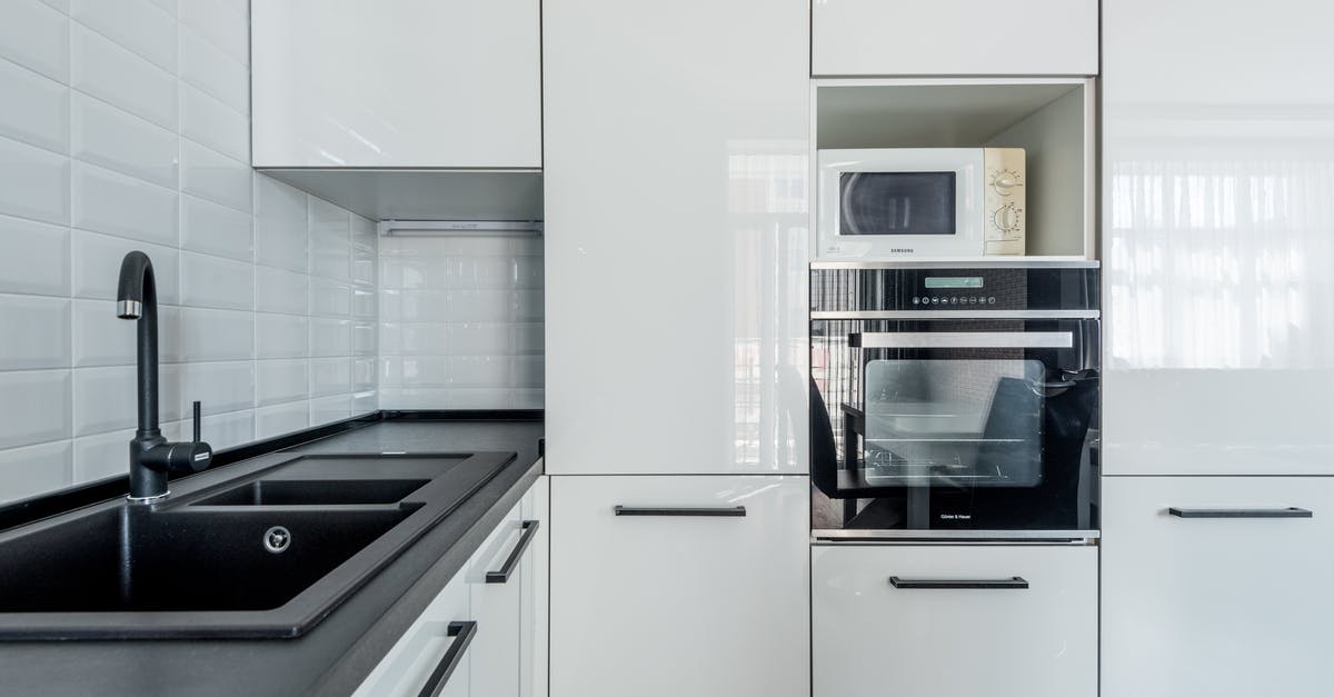 TSA PreCheck Renewal Residential Address Definition - Modern white kitchen with black sink and oven