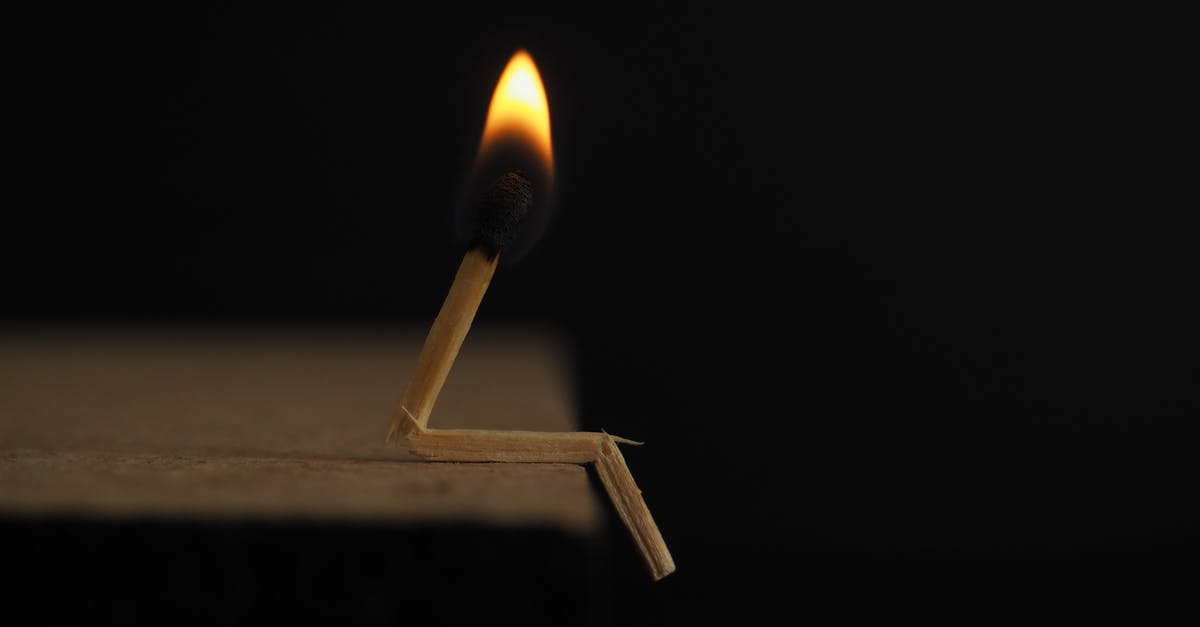 TSA Security Check - Flammable vs. Non-Flammable Aerosol - Lighted Matchstick on Brown Wooden Surface