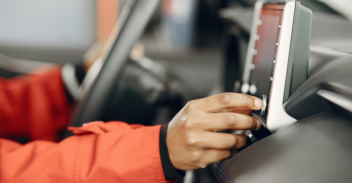 Turning off GPS on a flight? - Hand of a Person Turning On Car Stereo