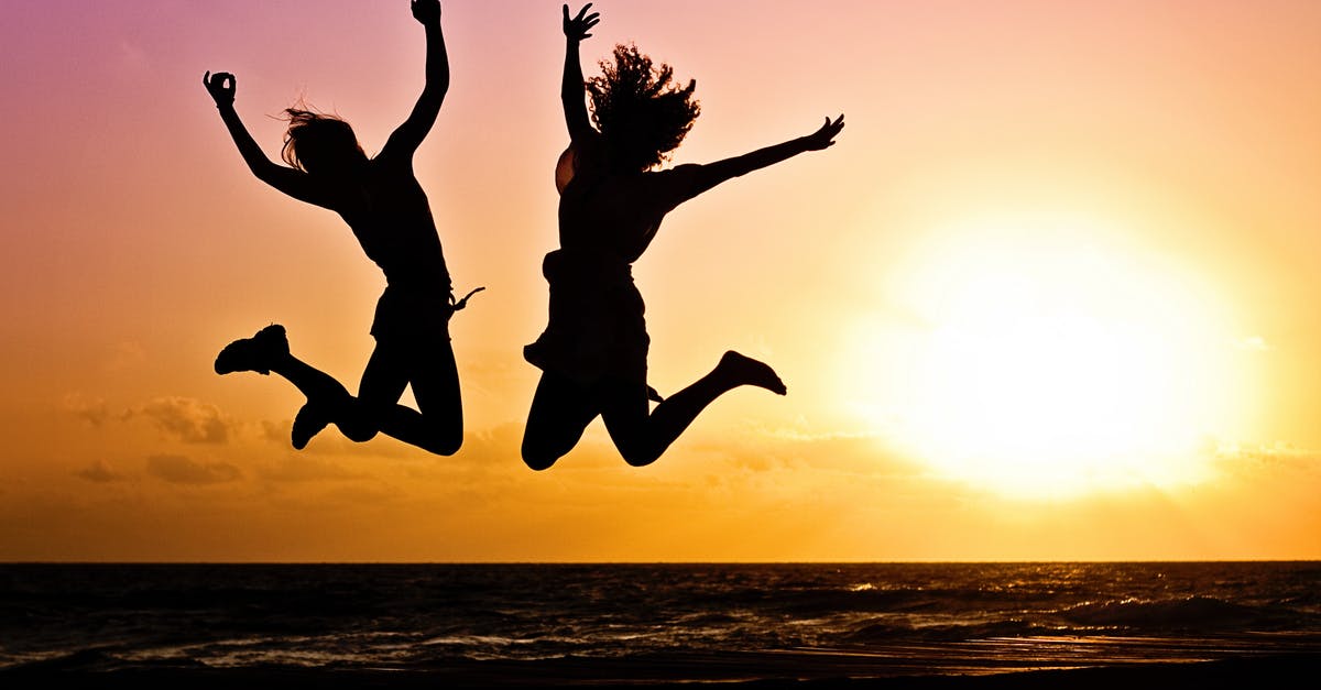 Two British passports, two visa -  Silhouette Photography Of Jump Shot Of Two Persons 