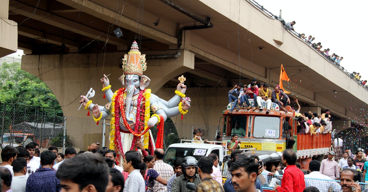 Two passport of the same person in India - People in Yellow and Red Costume Standing on Stage