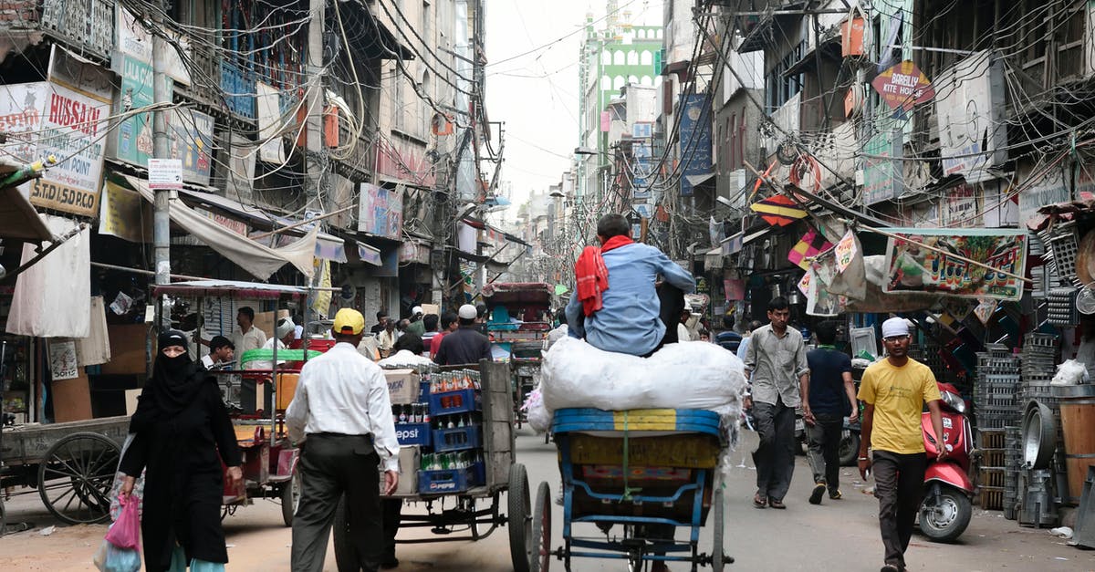 Two passport of the same person in India - People Walking on Street