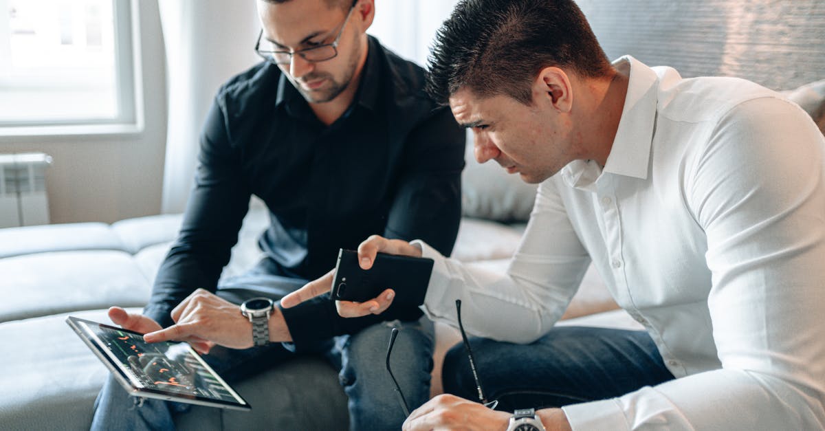 Two separate tickets for connecting flights - Two Men Pointing at iPad Screen
