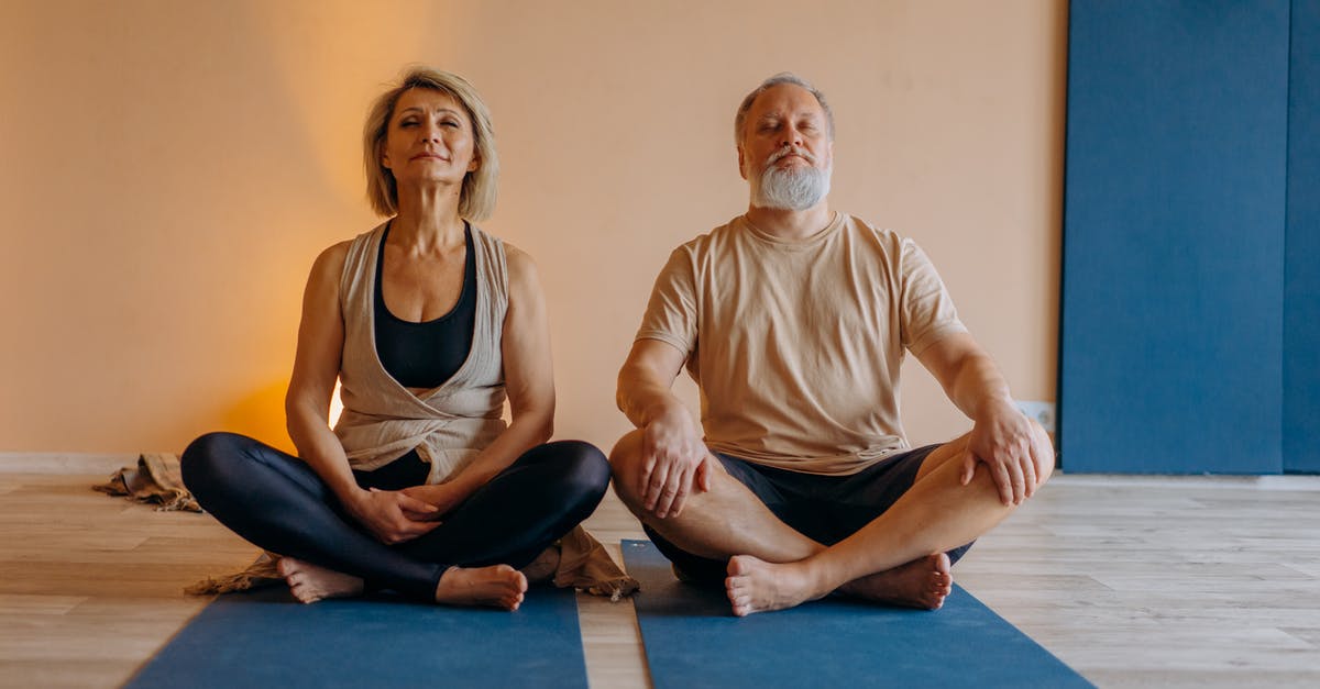 Two Weeks in Cambridge (England), practicing sport in group - Man and Woman Sitting on Blue Yoga Mat