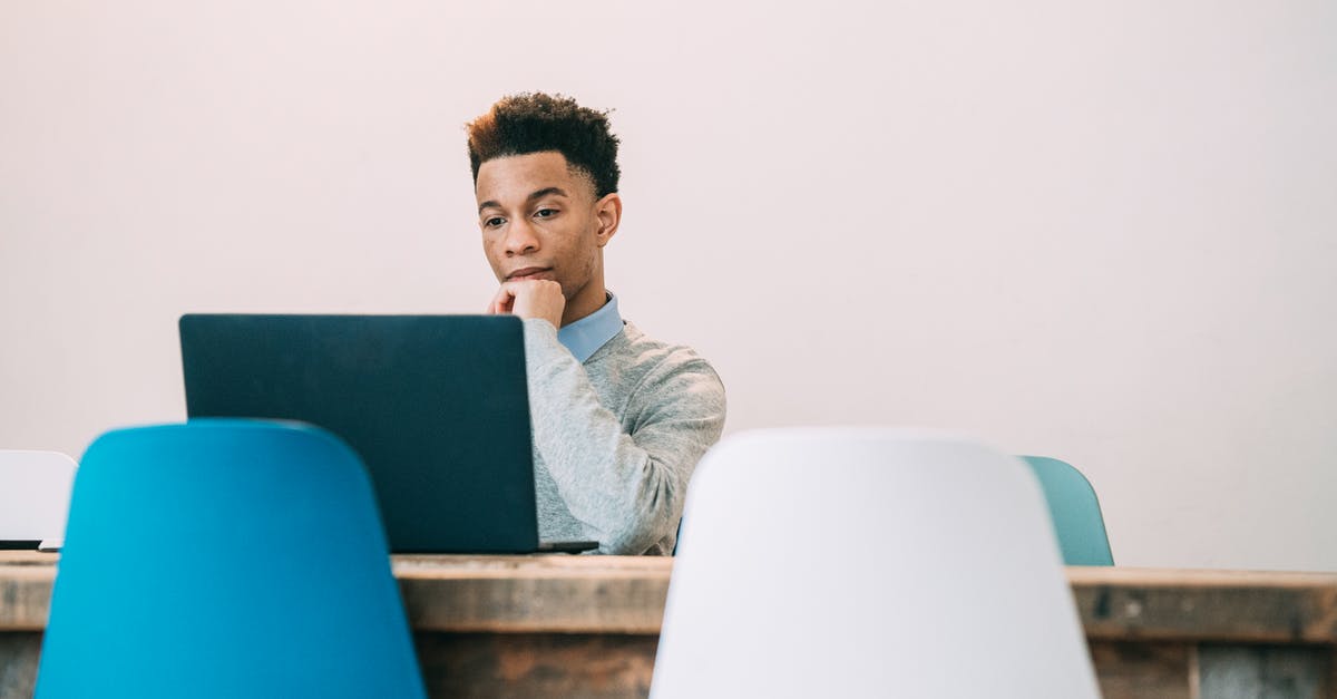 Type of Visa for attending a conference in Norway [duplicate] - Pensive ambitious African American male touching chin and using netbook at table of modern office on white background