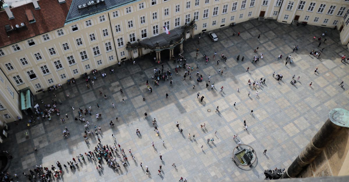 Uber from the airport in Prague - pickup location and reliability? - From above of travelers on square in front of aged vintage panoramic exploring sightseeing and studying place in daylight