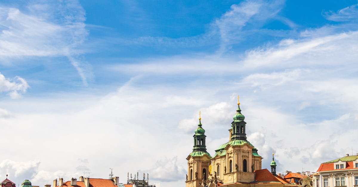 Uber from the airport in Prague - pickup location and reliability? - Exterior of aged Saint Nicholas church placed in Prague under cloudy blue sky in sunny day