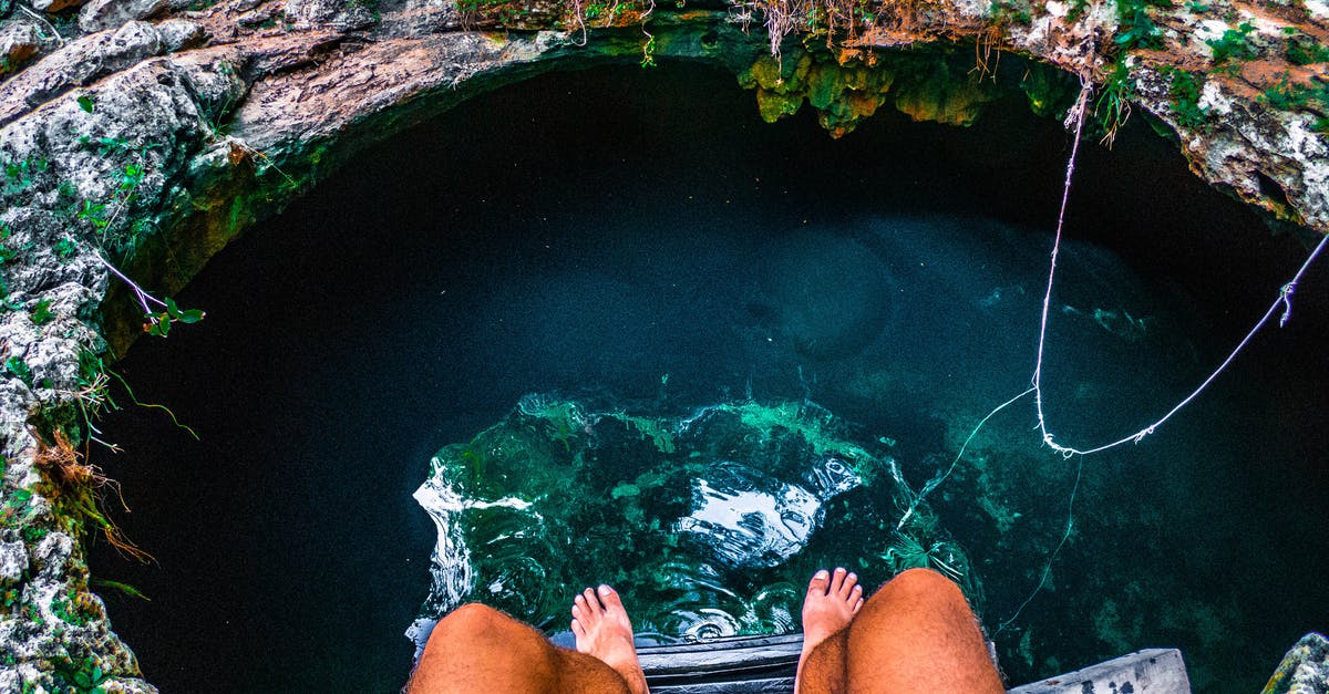 UK - Spousal Visa Travelling to Mexico for Holiday - Person Sitting on a Ladder With View Of Underground Water