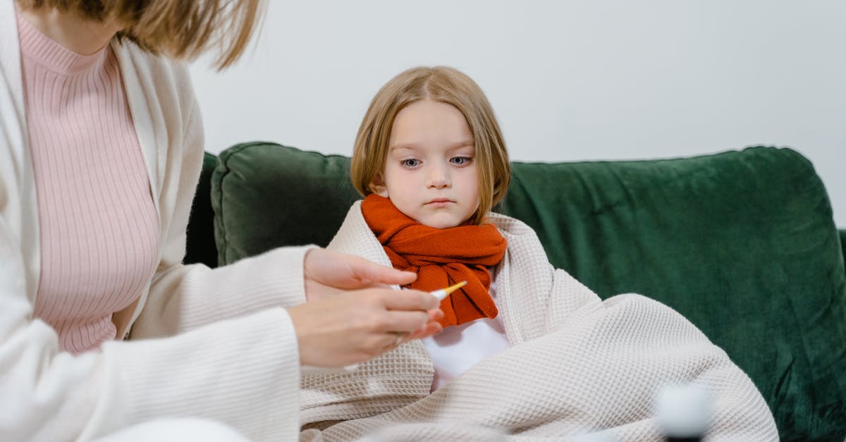 UK child visitor visa - Woman in White Sweater Holding Baby in Orange and White Sweater