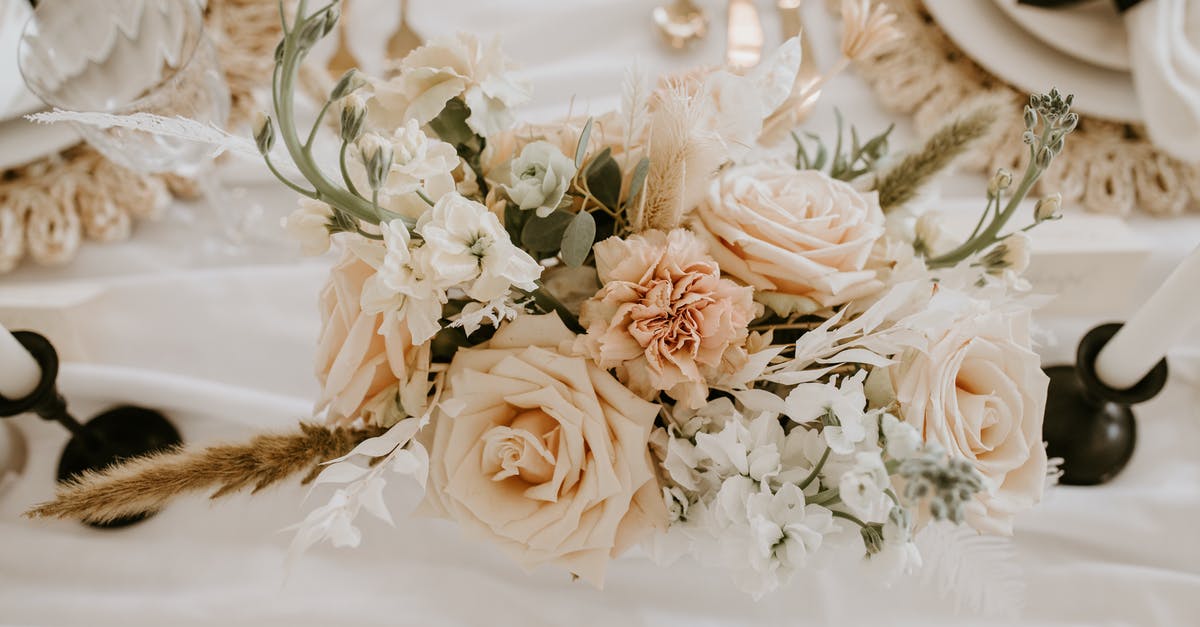 UK Marriage Visitor Visa (MVV) refusal and subsequent fresh application - Top view of delicate bunch of fresh flowers and branches decorating festive wedding table with dishware and candlesticks