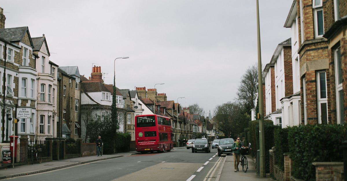 UK National Express Bus LHR > CBG — often fully booked? - Cars on the Road Between Apartment Buildings