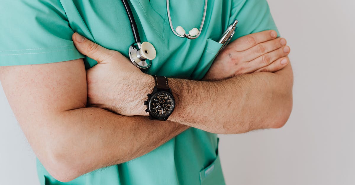 UK Passport: Emergency appointment (supporting documents) - Unrecognizable crop man in wristwatch with stethoscope