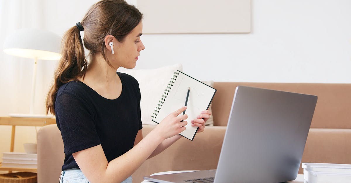 UK Visa application for conference - Self employed - Focused woman using laptop while attending online webinar