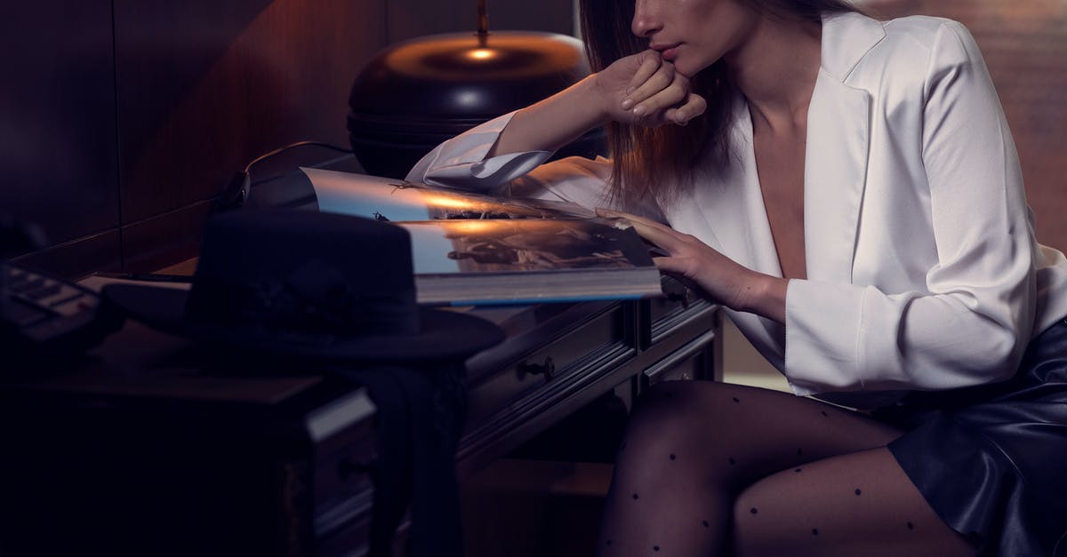 UK visa hotel booking and contact information - Elegant young lady reading magazine in cozy hotel