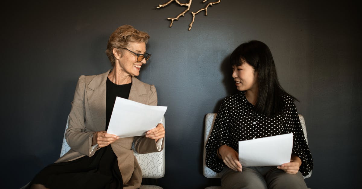 UK visa interview documents - Women Sitting on Chairs Holding Documents