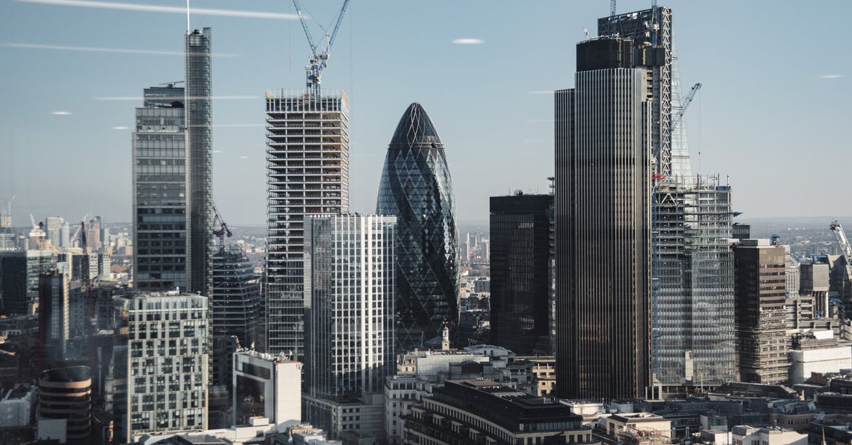 UK visit visa refusal: insufficient financial documentation - Various shaped modern skyscrapers with glass mirrored facades located in financial district of London against blue sky on sunny day