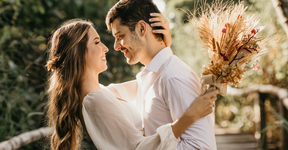 UK visit visa to get married rejected [closed] - Side view of delightful newlyweds hugging and looking at each other while standing outside on blurred background