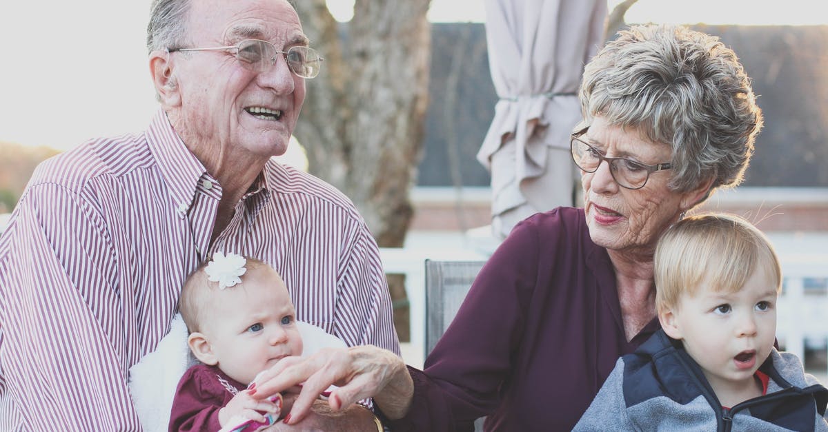 UK visiting visa for a 3 year old child - Grandmother and Grandfather Holding Child on Their Lap