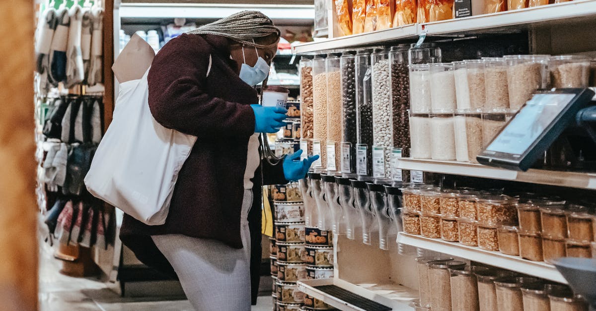 UK Visitor Visa application NY decision delayed - Black woman choosing grains in supermarket