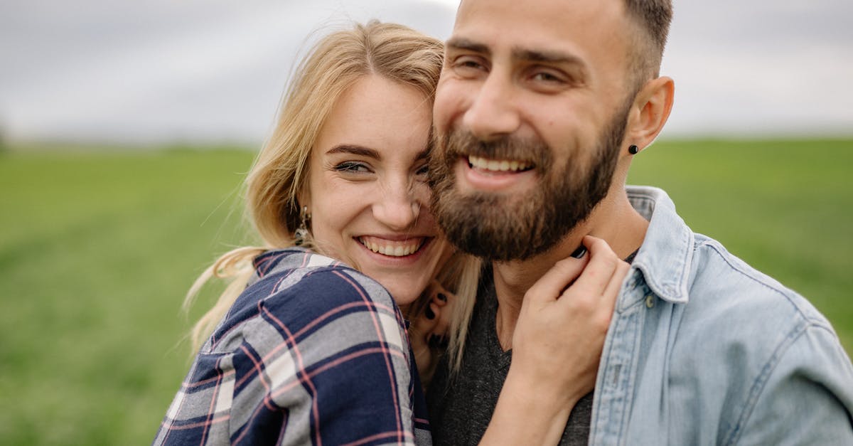 UK Visitor Visa for Girlfriend - Man in Blue Denim Button Up Shirt Beside Woman in Purple and White Plaid Shirt