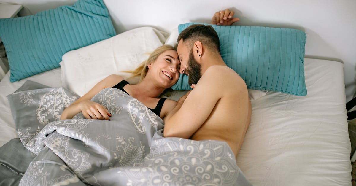 UK Visitor Visa for Girlfriend - Couple Cuddling in Bed under Covers