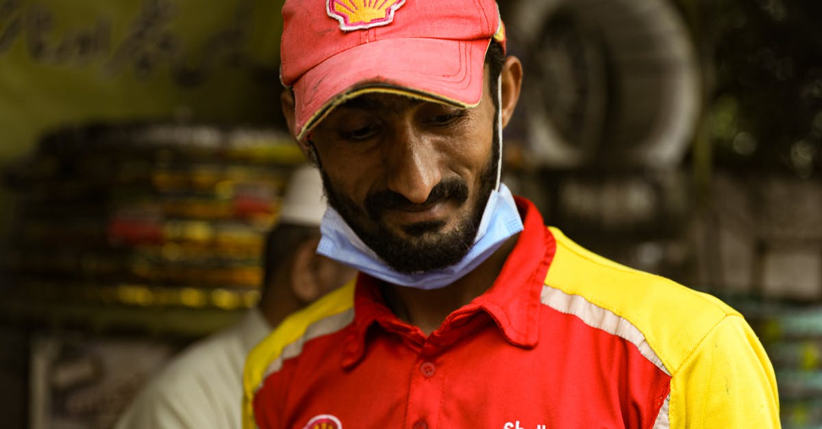 UK visitor visa from Lahore Pakistan - Man Wearing Polo Shirt and Red Cap