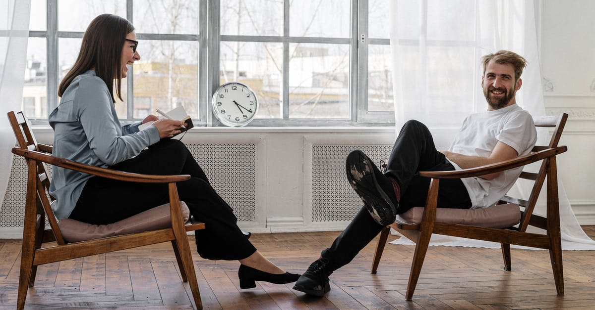 UK Visitors and NHS Health Services - 2 Women Sitting on Brown Wooden Chair