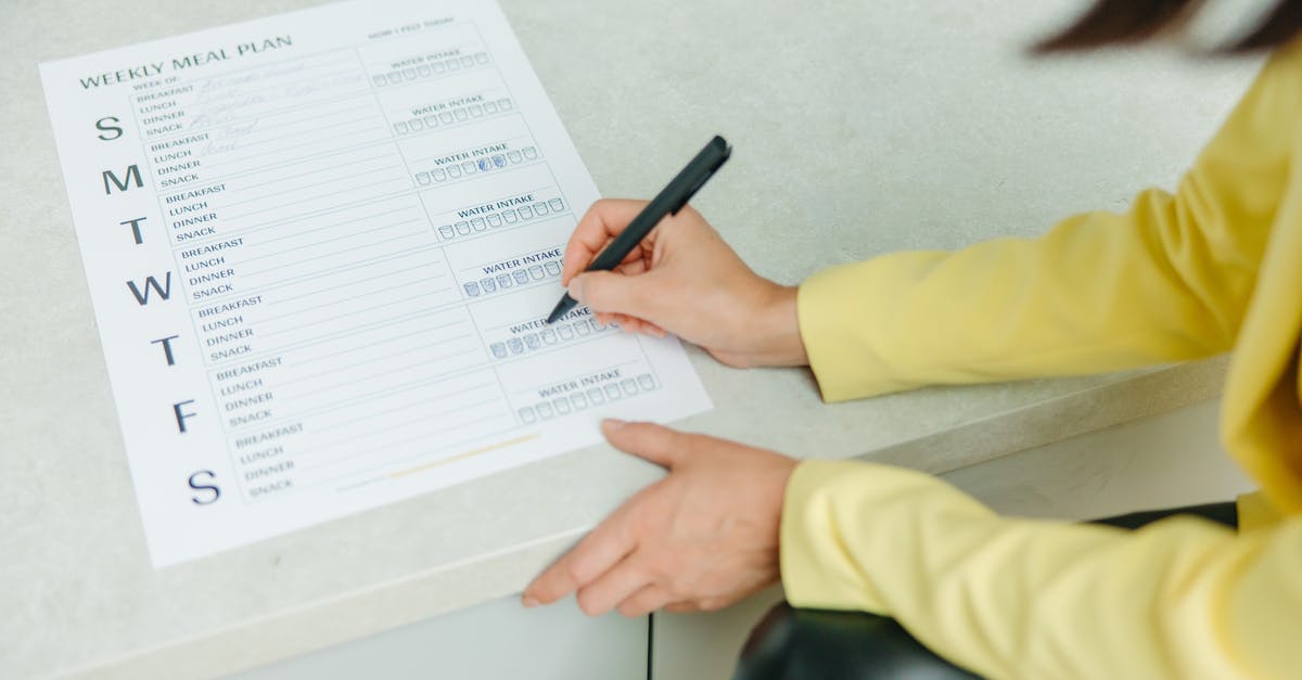 UKVI checklist not signed - Person Holding Black Pen Writing on White Paper