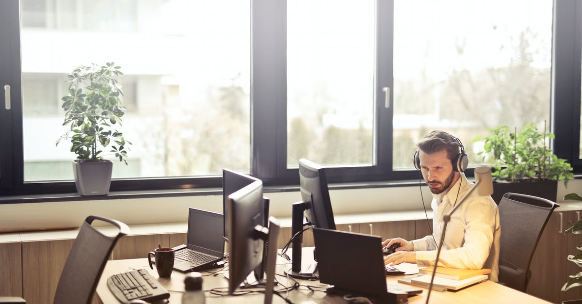 UKVI helpline Question - Man With Headphones Facing Computer Monitor