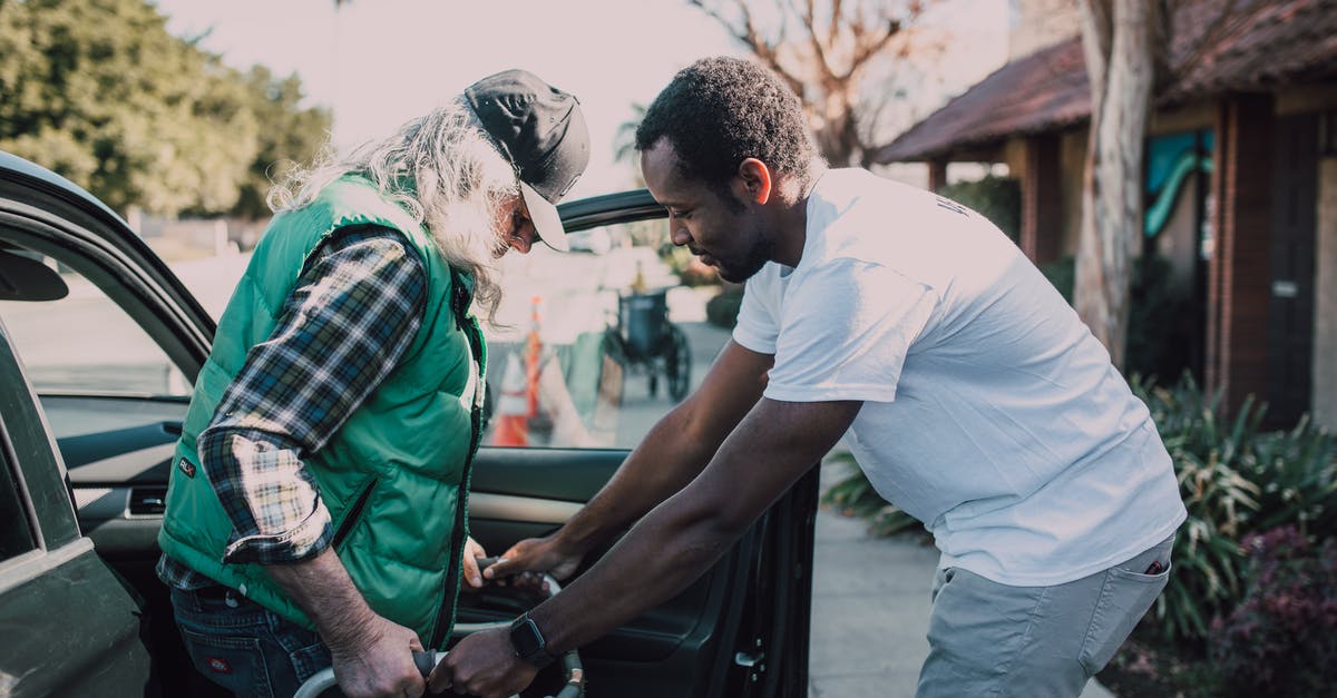 Understanding car rental fees - Man Assisting Person with Walker