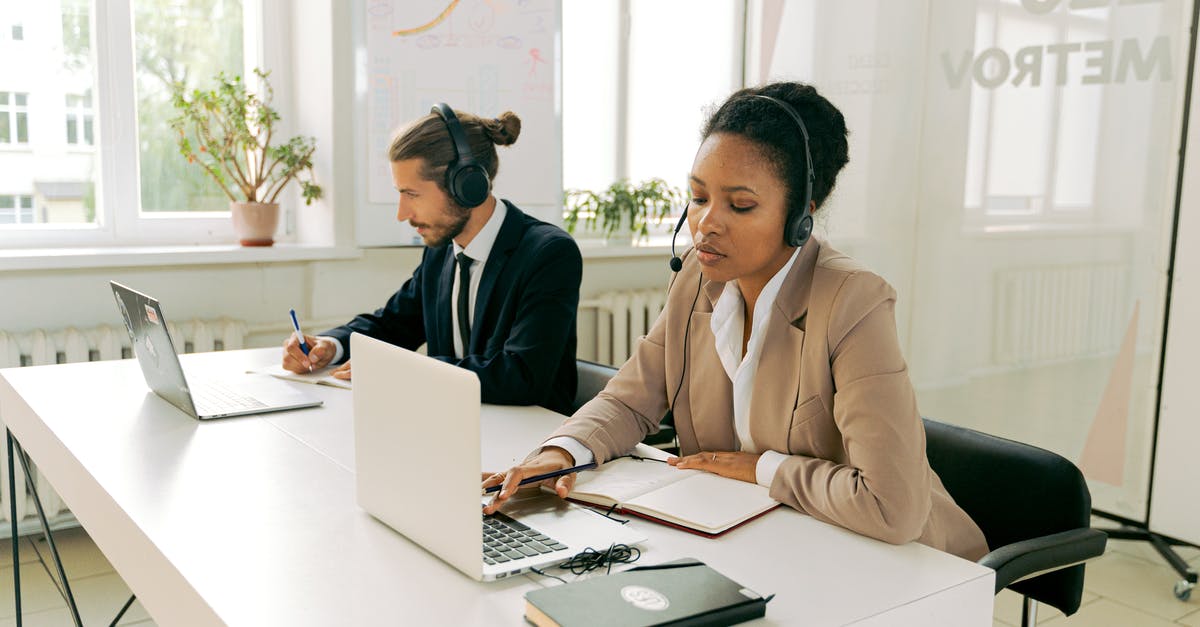 Understanding how customs work with laptops - Man and Woman Working Wearing Headsets 