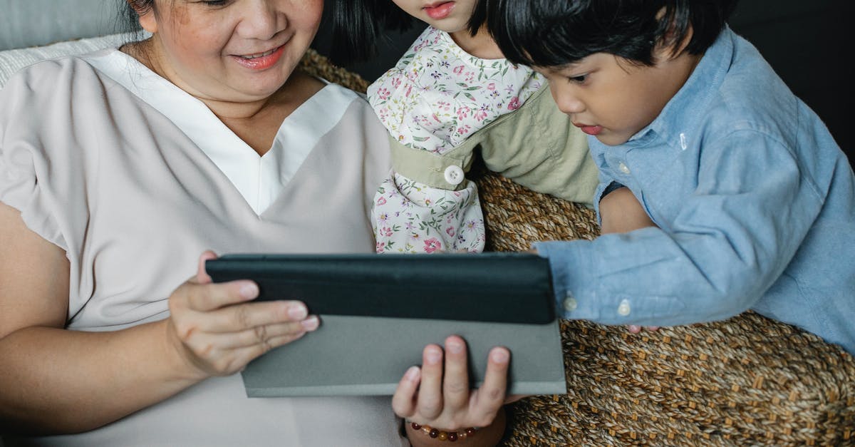 Undisclosed relative [closed] - Anonymous Asian woman with grandchildren watching video on tablet