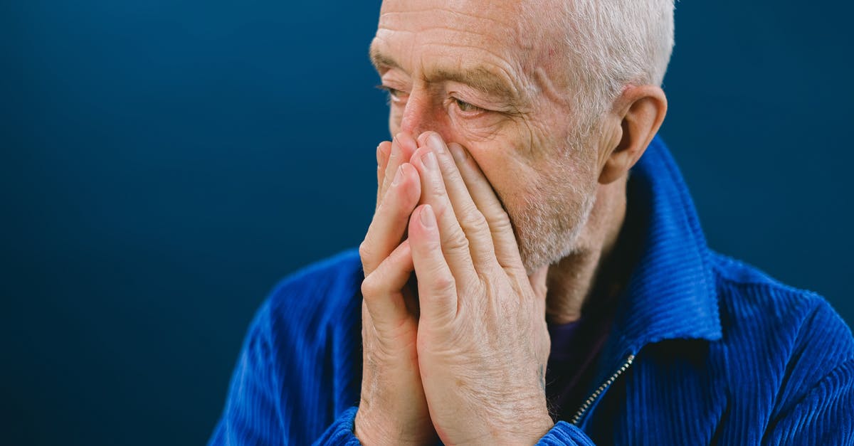 Unexpected hospitalization in the EU without EHIC, am I covered? - Stressed elderly man covering mouth