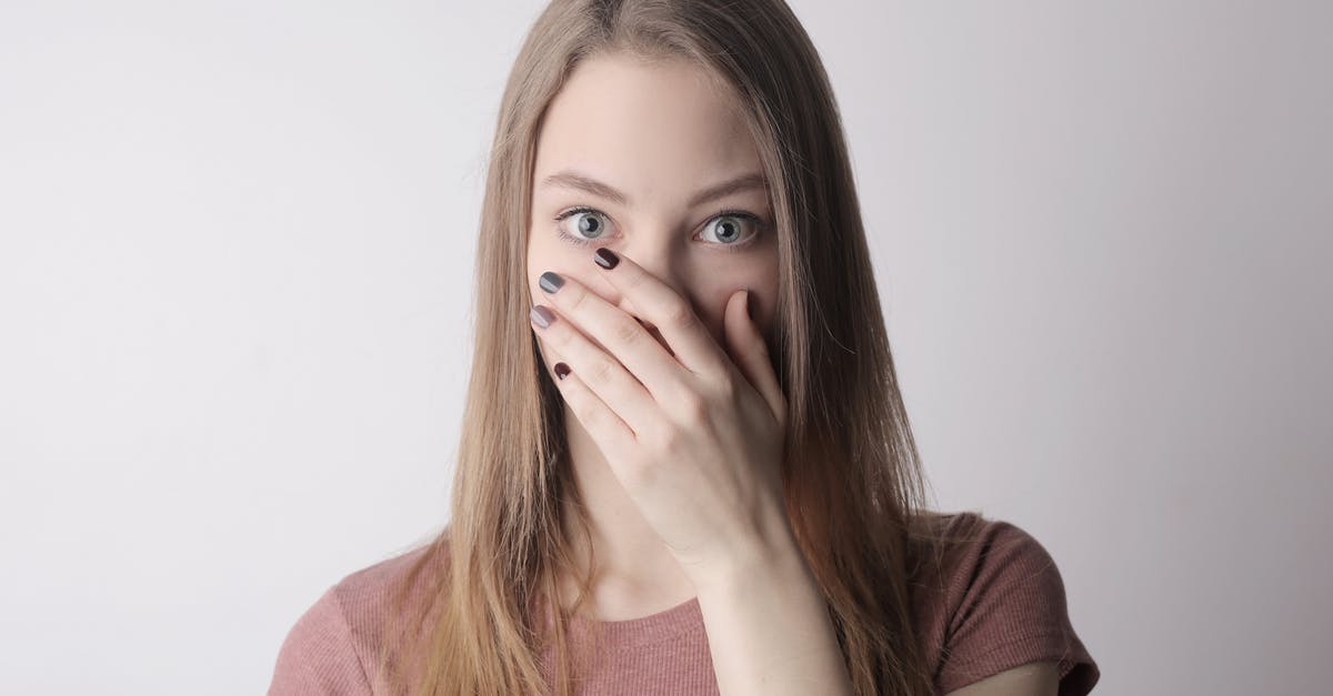 Unexpected hospitalization in the EU without EHIC, am I covered? - Young amazed woman in casual wear covering mouth while keeping secret