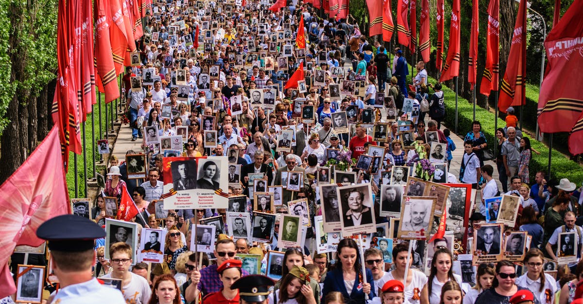 United Kingdom transit visa for 4-5 days [duplicate] - Parade of People Walking Together Carrying Banners with Pictures 