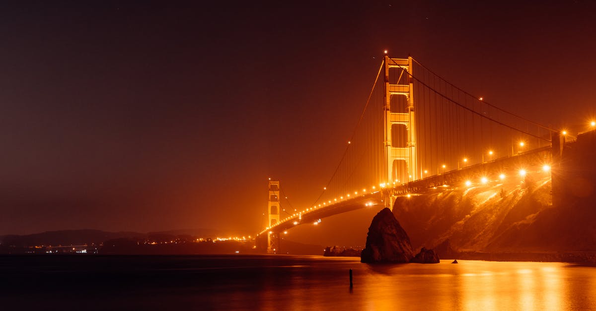 United States National Radio Quiet Zone: Impact on travellers? - Bright Golden Gate Bridge above water at night