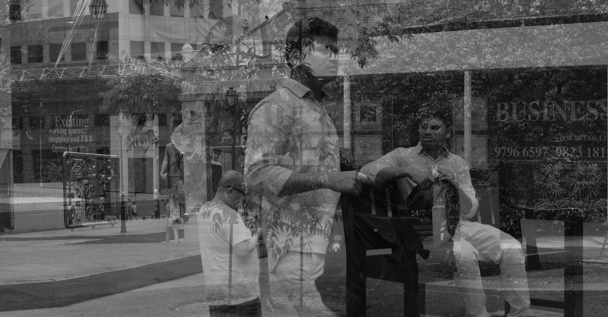 Unplanned backpacking across several European countries - Man Walking Holding Backpack and Sitting on Bench Reflection on Glass