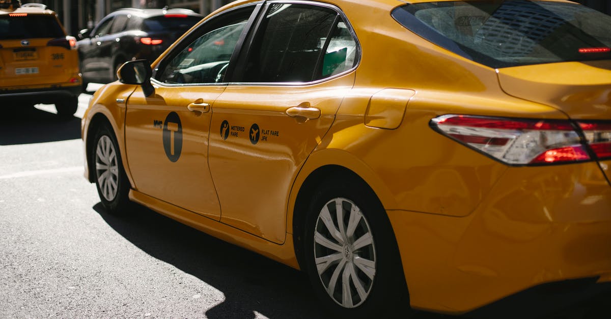 US Driving - pulling onto a busy highway using on/off ramp - Shiny yellow taxi driving along busy street in downtown