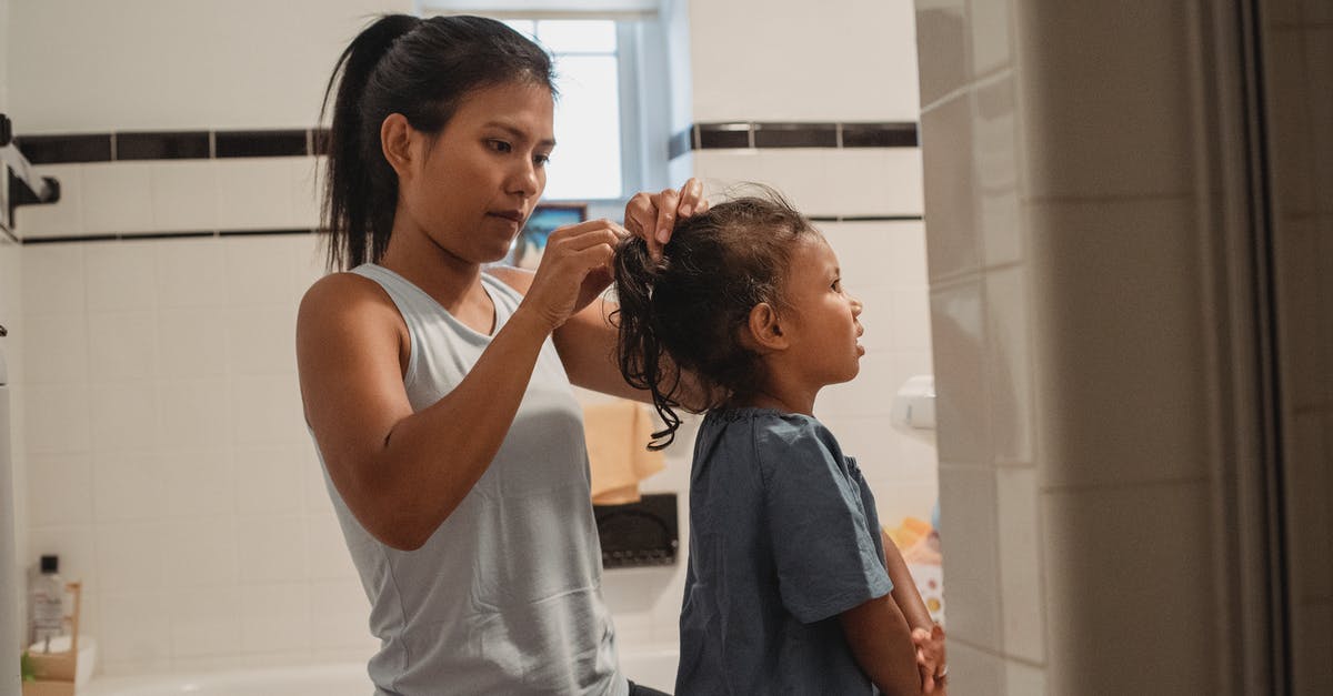 US Visa process for children, how long does it take? - Side view of young Hispanic female in casual outfit standing in bathroom and braiding little daughter