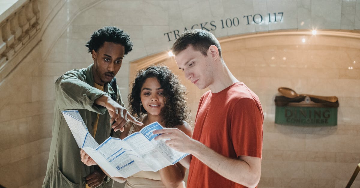 USA tourist visa application for a student - Young focused diverse students exploring map in railway station