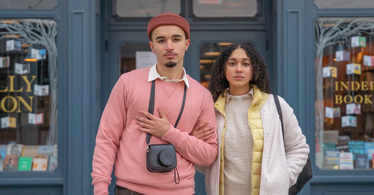 USA tourist visa first time entry date [duplicate] - Stylish young ethnic female and male travelers in stylish outfits standing together on city street near aged bookstore and looking at camera