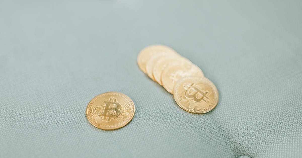 use Bitcoin in Iran - Gold Round Coins on White Textile