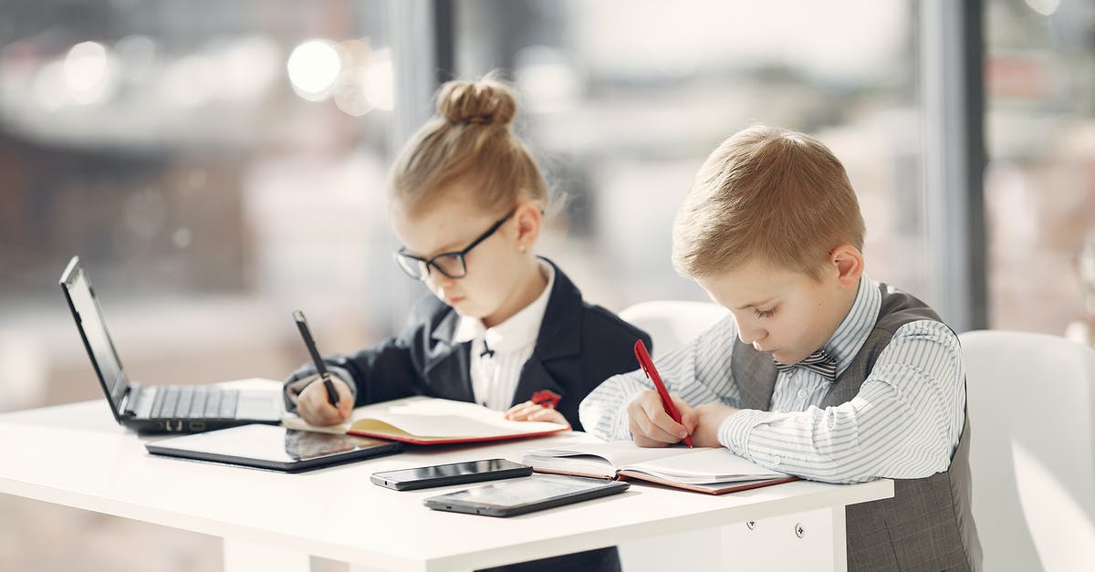 Using 1,000 CHF notes in Switzerland - Serious preschool managers in uniform planning schedule in notebooks while sitting in front of modern devices in contemporary workplace