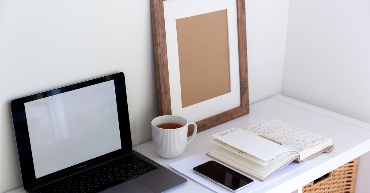 Using a data mobile wi-fi device abroad (UK to Spain) [closed] - From above of empty frame placed near laptop daily planner and cup of hot drink and mobile phone in between in light room