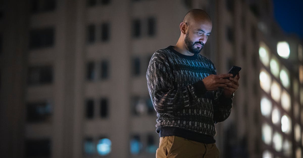 Using a quad-band phone in Japan? - Man with Beard Using a Phone in a Street