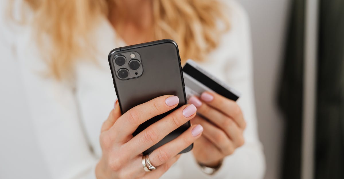 Using an iPhone 4S in South Korea - Close-Up Shot of a Person Holding a Credit Card and a Smartphone