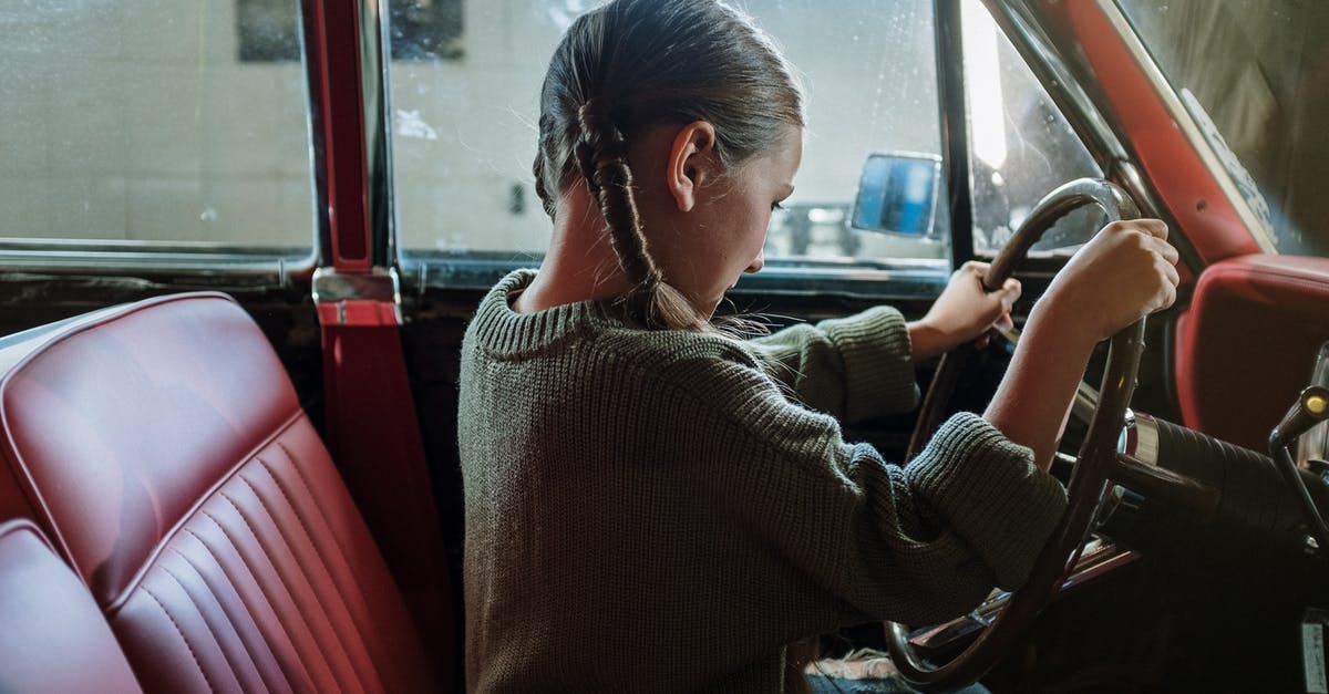 Using child car seats in Cuba? - Woman in Gray Sweater Sitting on Red Car Seat