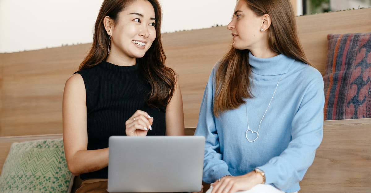 Using status across other Star Alliance airlines? - Content cheerful diverse women talking and using laptop