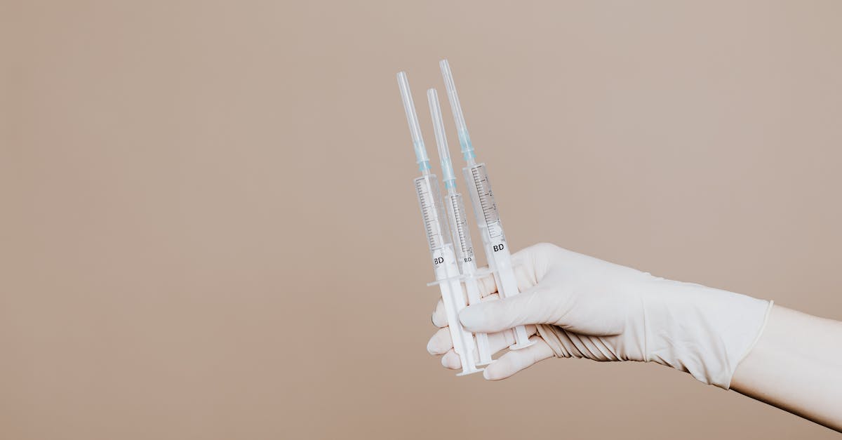 Vaccinations and medicines for Peru and Ecuador - Person Holding Three Syringes with Medicine