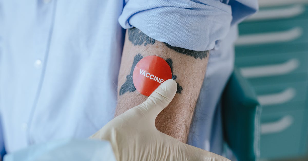 Vaccine certificate conditions for Armenia entrance - Person Holding Orange Ball on Blue Textile